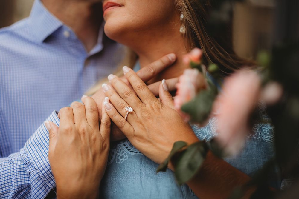 Close-up view of hands clasped together in an intimate moment during a wedding ceremony.