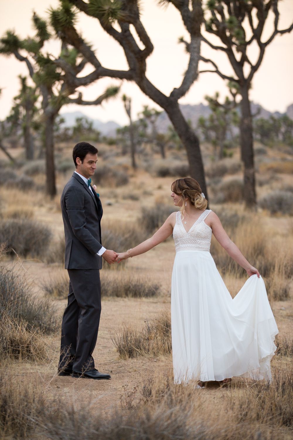 A couple has their first dance surrounded by Joshua trees in Northern California.