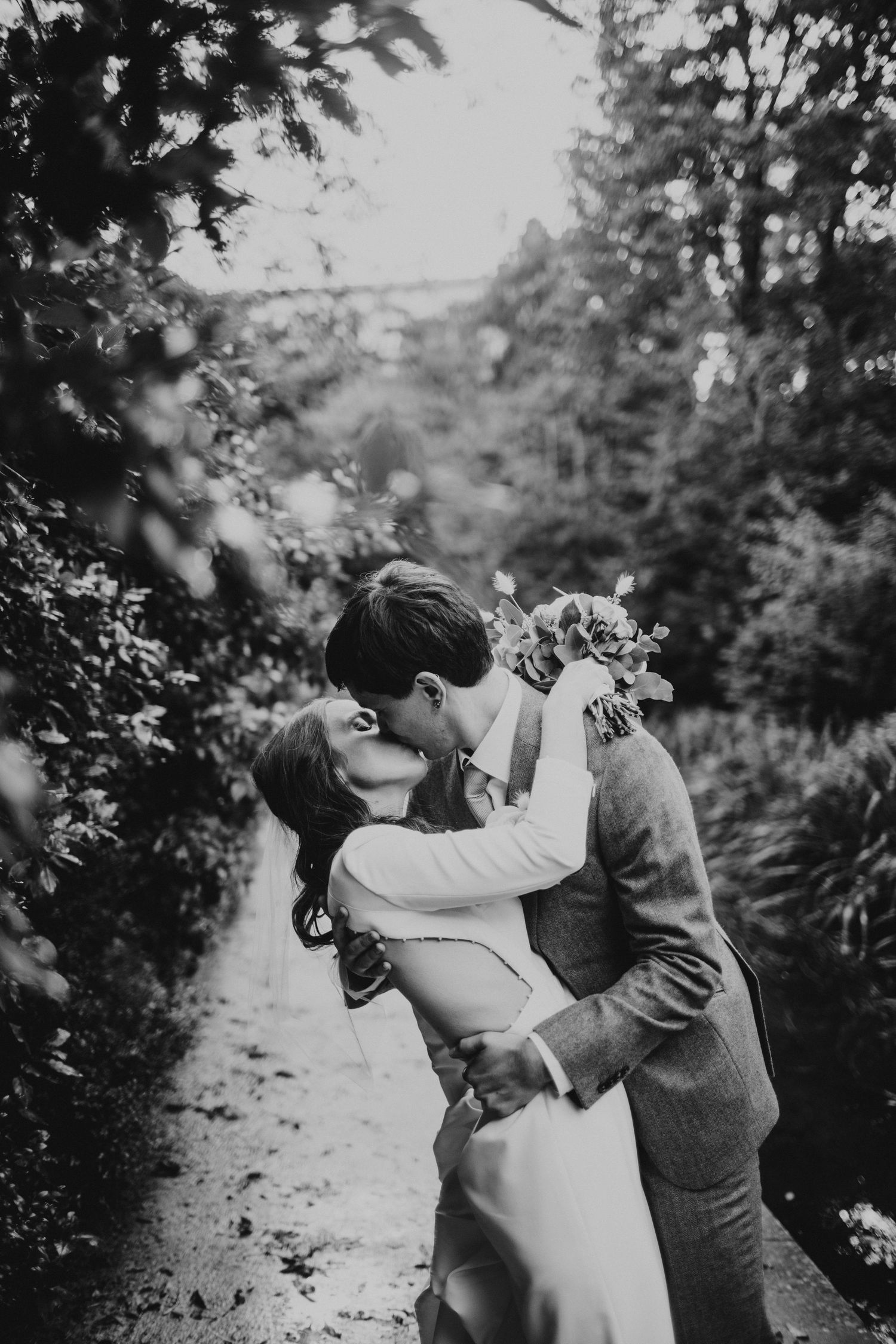 Couple kissing during a couple  photoshoot at Prior Park in Bath