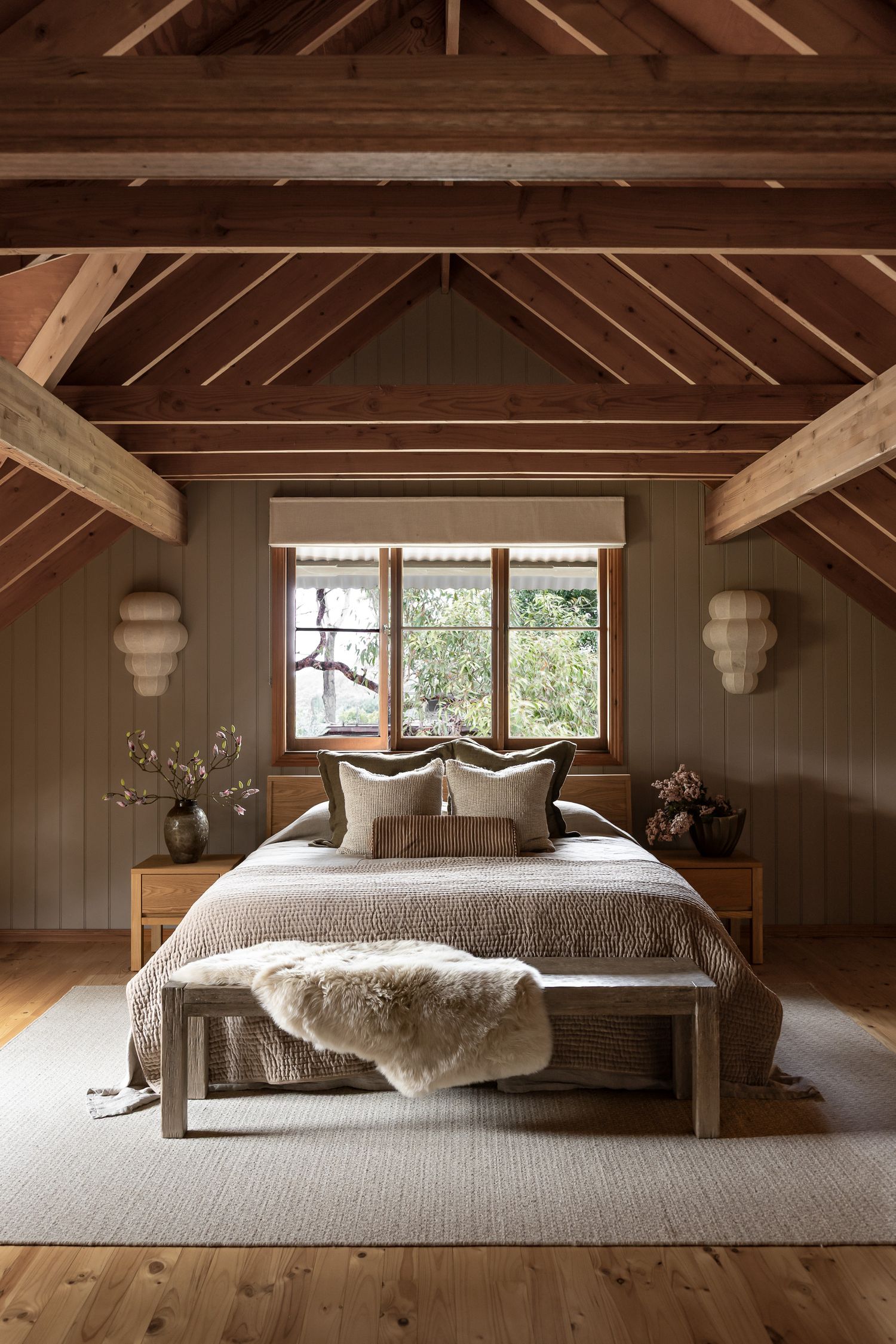 Warm timber bedroom with exposed rafters captured in a coastal cottage in Hyams Beach, NSW by Life in Still interior photographer.