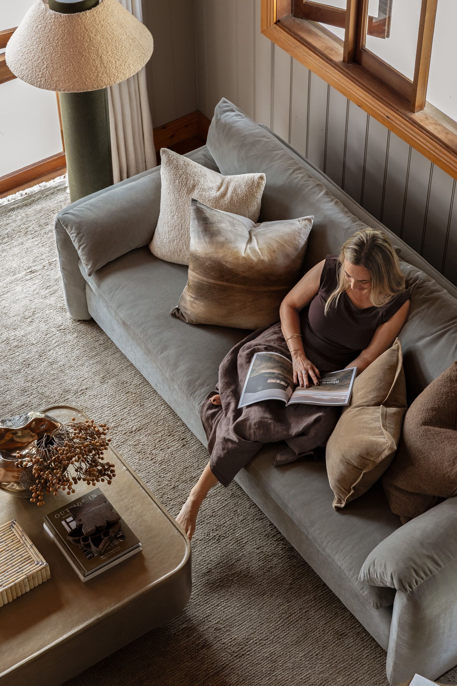 Moody attic living room with exposed timber ceilings photographed in a coastal cottage on the South Coast of NSW.