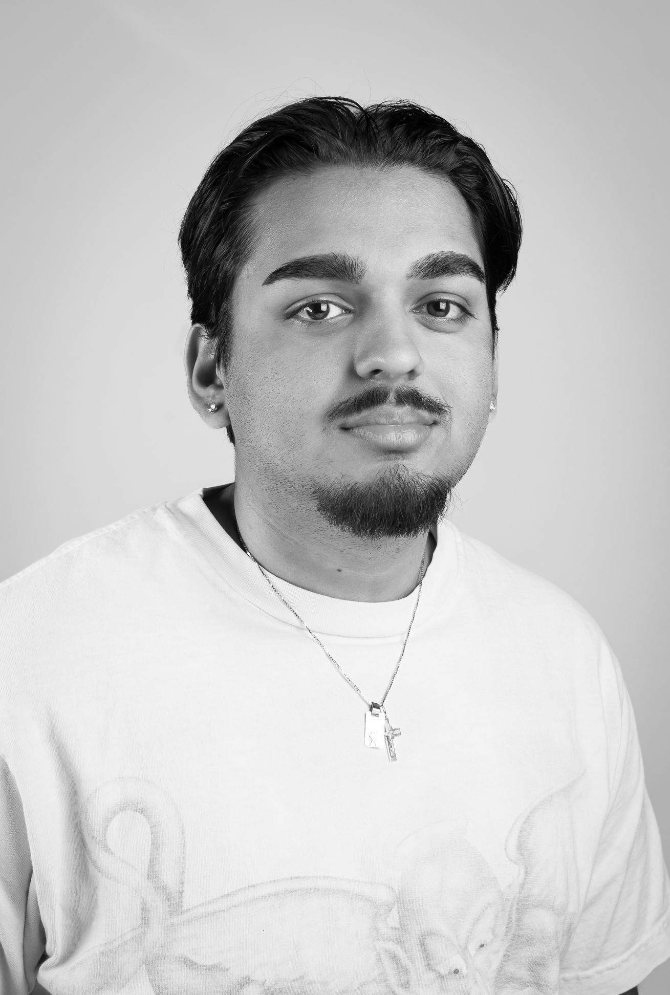 Black and white image of a boy in a white shirt smiling