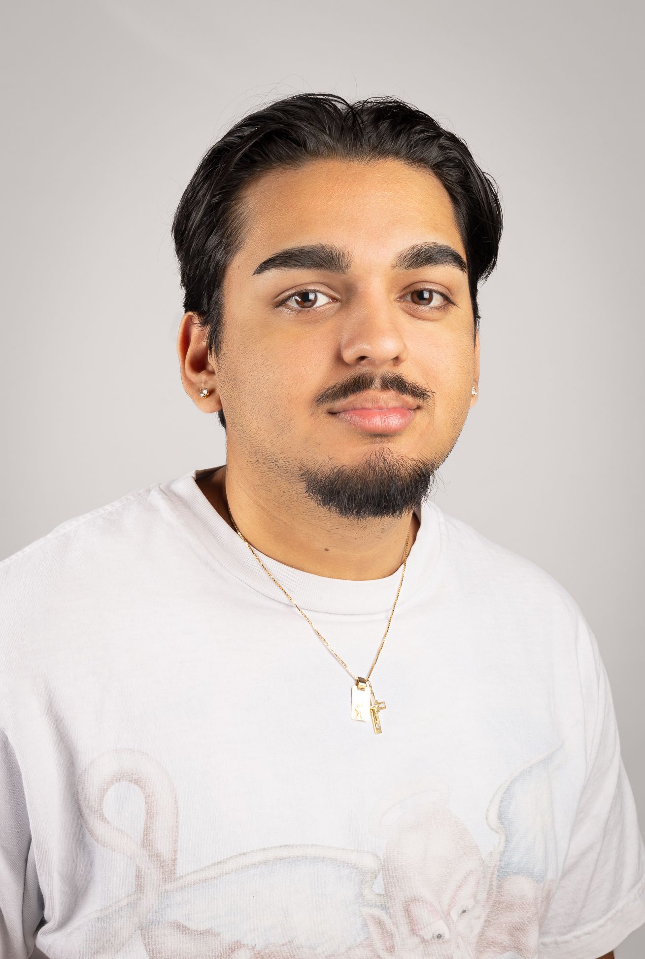 Image of a boy in a white shirt smiling, side angle