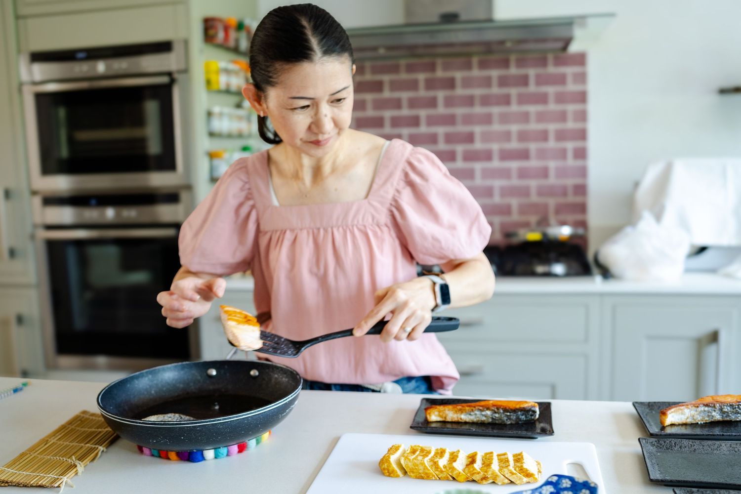 Private chef cooking in her home kitchen for her branding photography session in Kent
