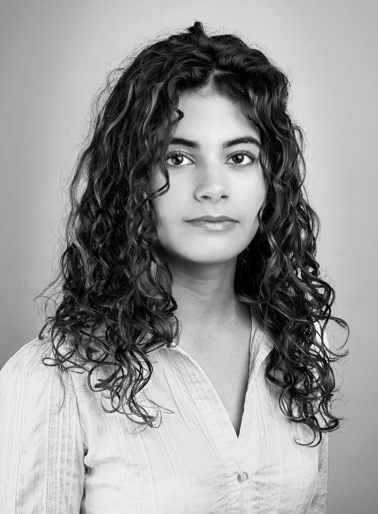 Black and white portrait image of a girl looking at the camera (headshot)