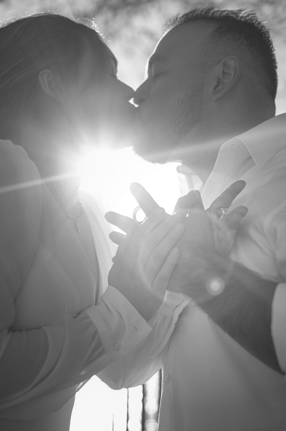 elopement photo take with the sunlight showcasing their wedding rings taken by Jessica Rae Photography.