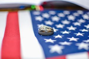 Wedding rings photographed on an American flag with selective focus.