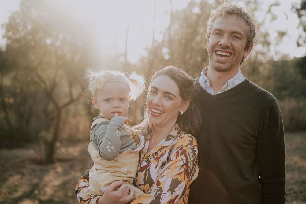 A candid family moment filled with laughter and joy in the golden sunset.
