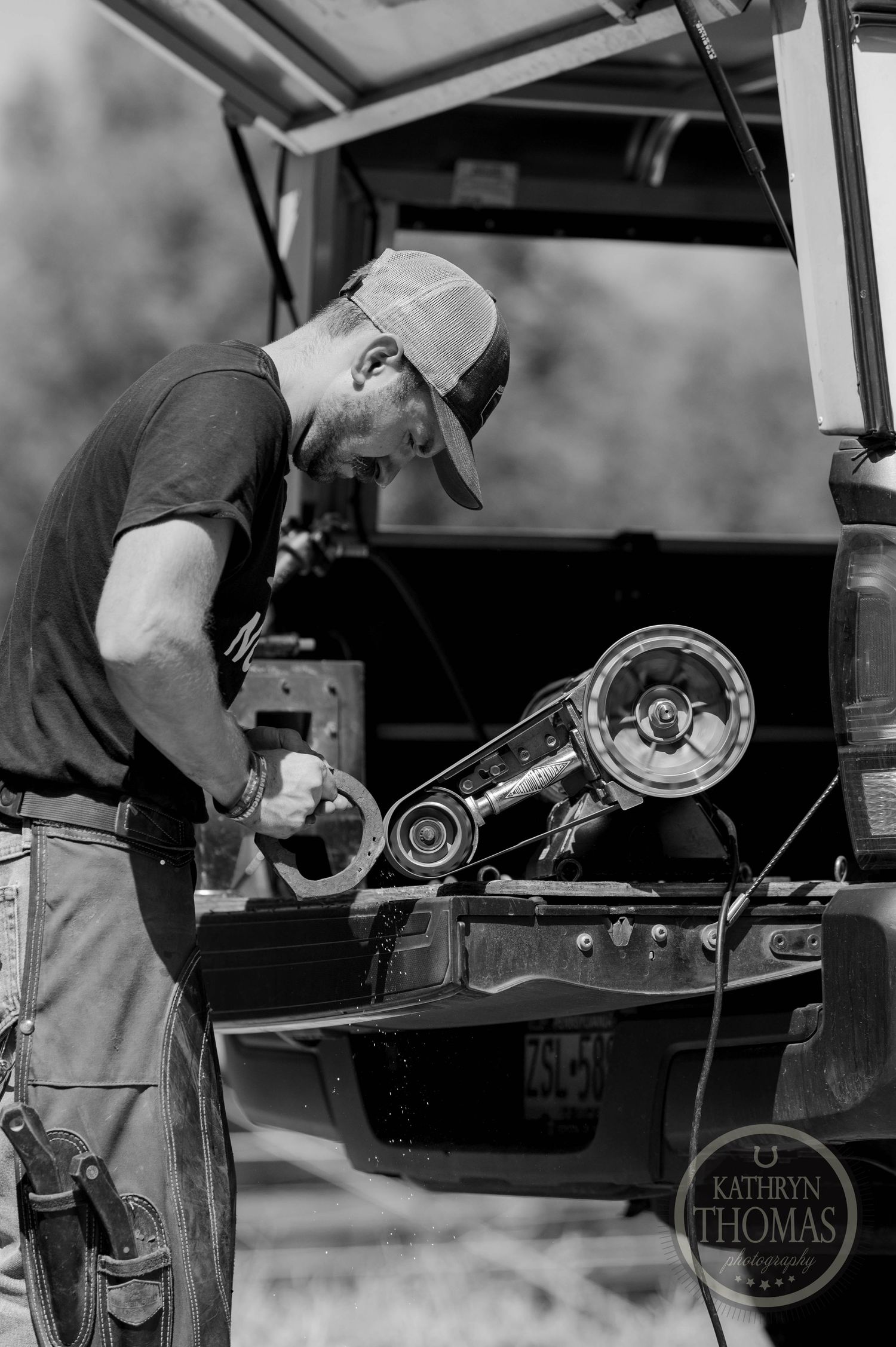 Farrier working to shape a horseshoe.