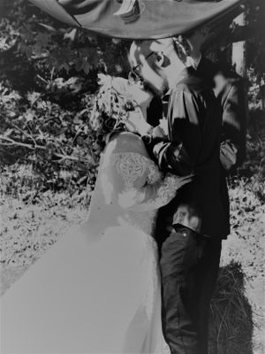 Intimate black and white wedding moments captured in a natural outdoor setting.