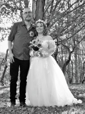Casual outdoor wedding photos featuring rustic elements and natural woodland backdrop.