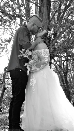 Romantic black and white wedding portraits captured in a natural wooded setting.