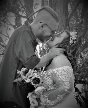Black and white wedding portraits capture intimate moments between a couple in nature.