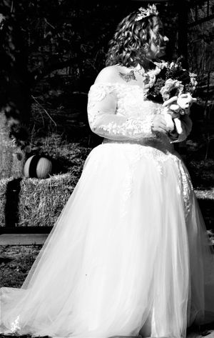 Close-up details of a bride's white tulle wedding dress with lace accents.