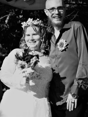 A happy couple shares a joyful moment together on their wedding day outdoors.