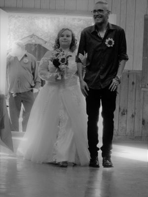 Black and white photo of people's legs and feet dancing on a wooden floor.