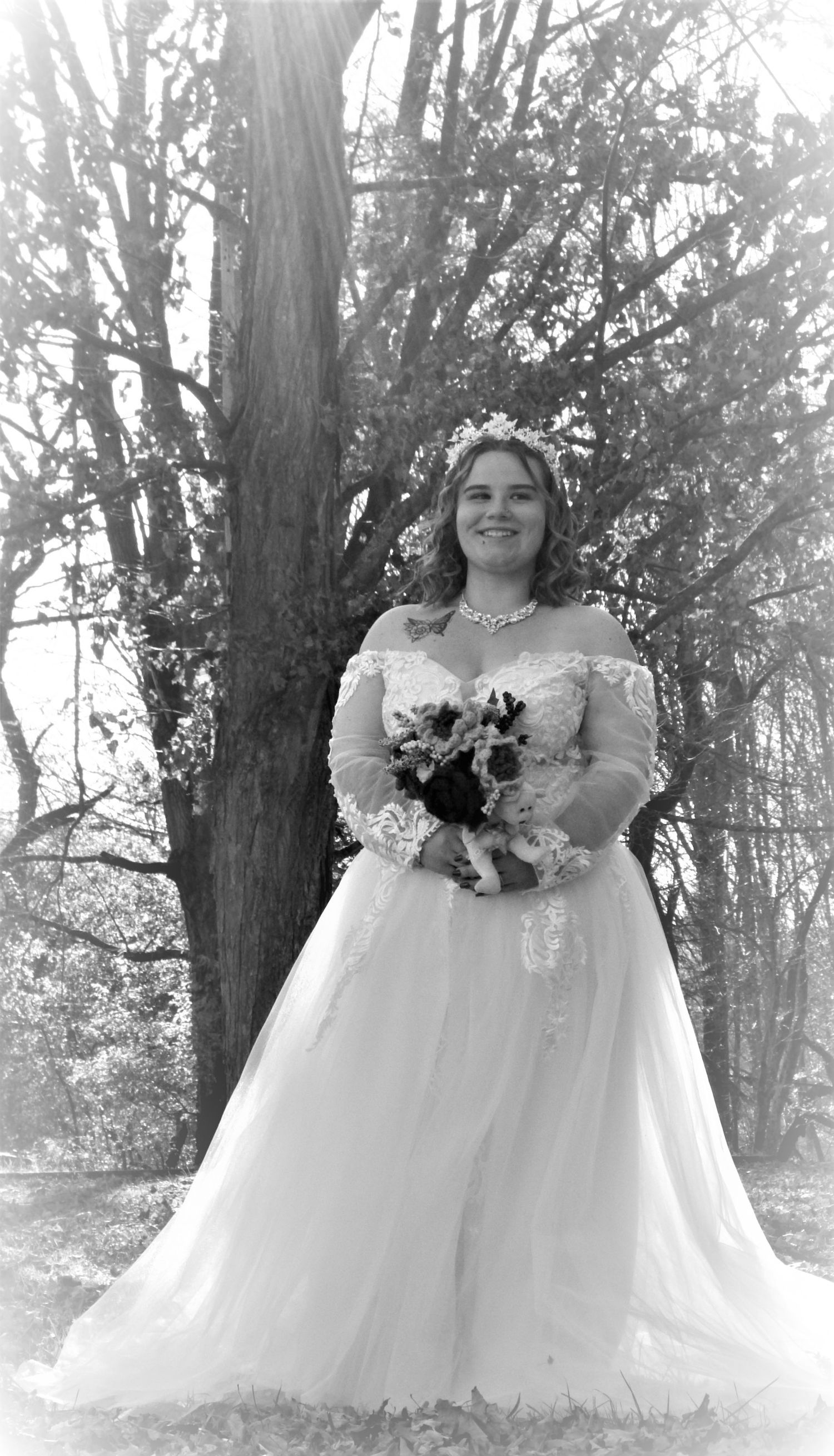Bride in a white ballgown poses for a series of ethereal photos in a wooded outdoor setting.