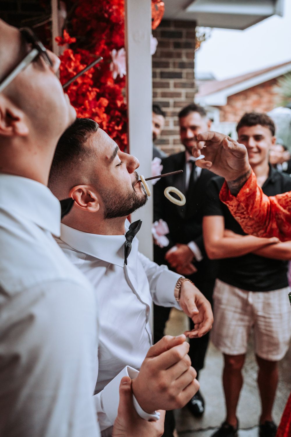 Friends celebrate at an outdoor gathering with lively reactions and expressions.