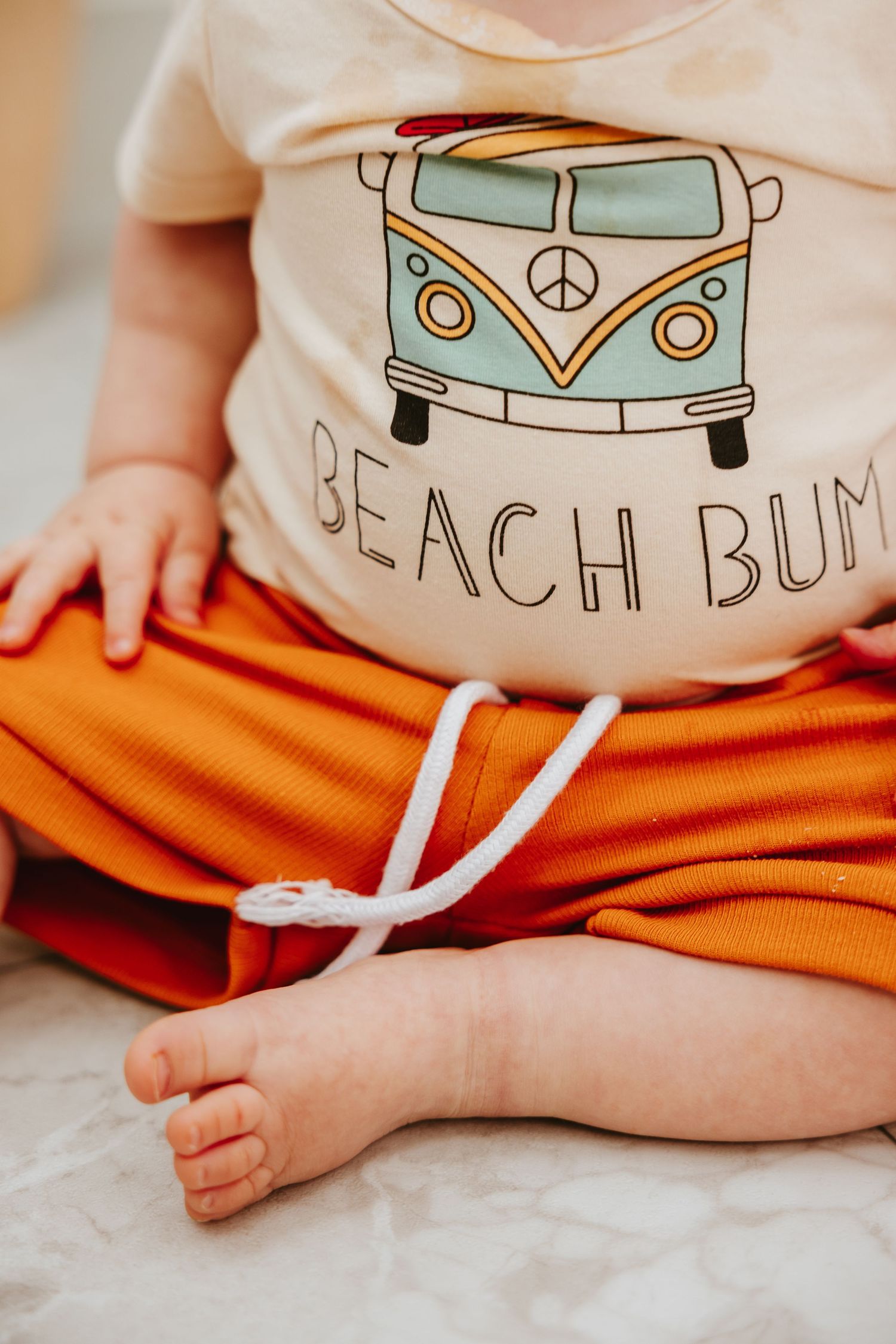 Close-up of a Beach Bum t-shirt featuring a light blue VW bus design.