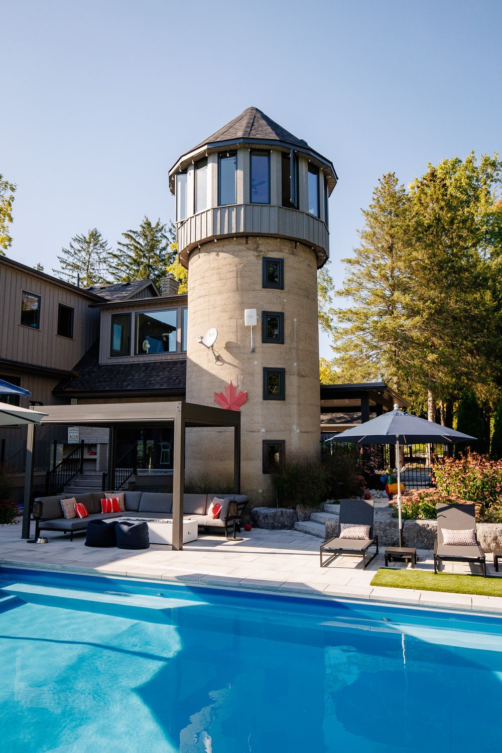A renovated old silo now featured on a modern home with a room in the tower.