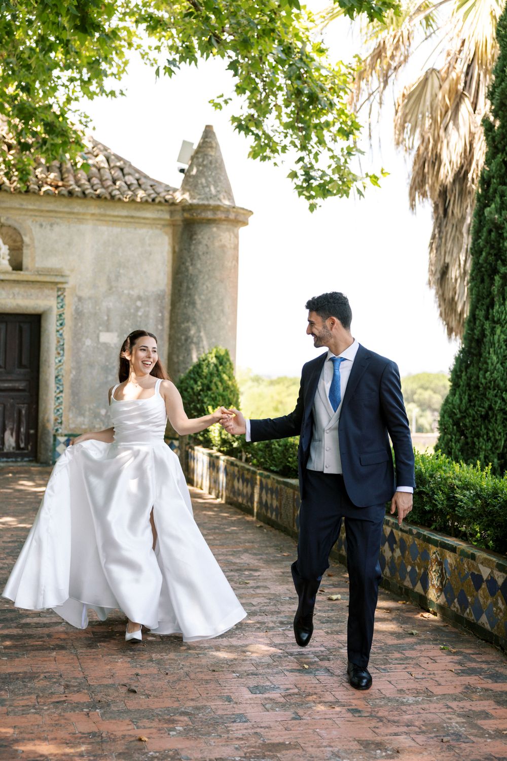 Destination wedding couple walking in historic Portuguese estate in Portugal