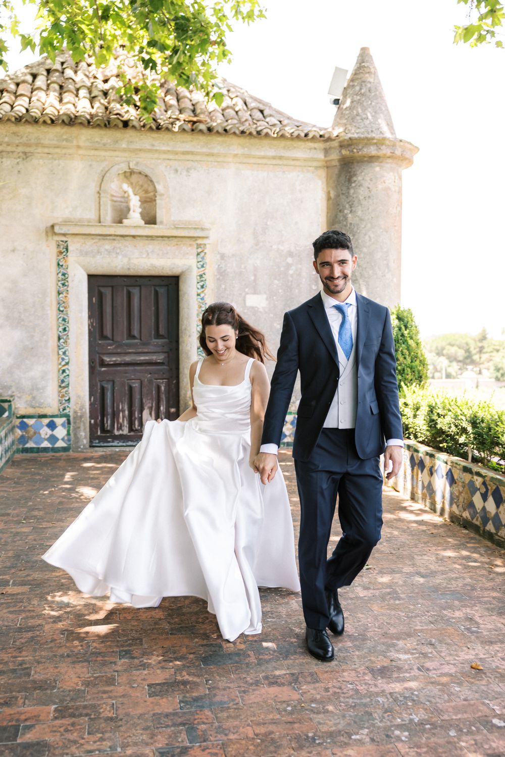 Bride and groom walking at Palácio da Bacalhôa wedding in Portugal