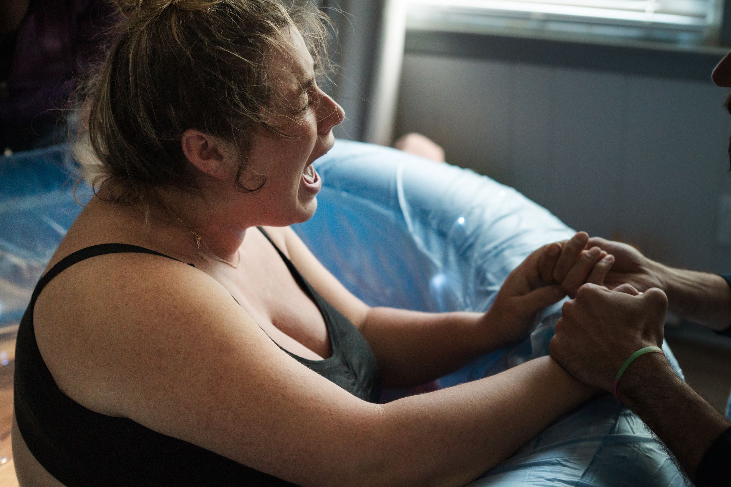 Professional massage treatment being performed on person resting on massage table in a clinical setting.