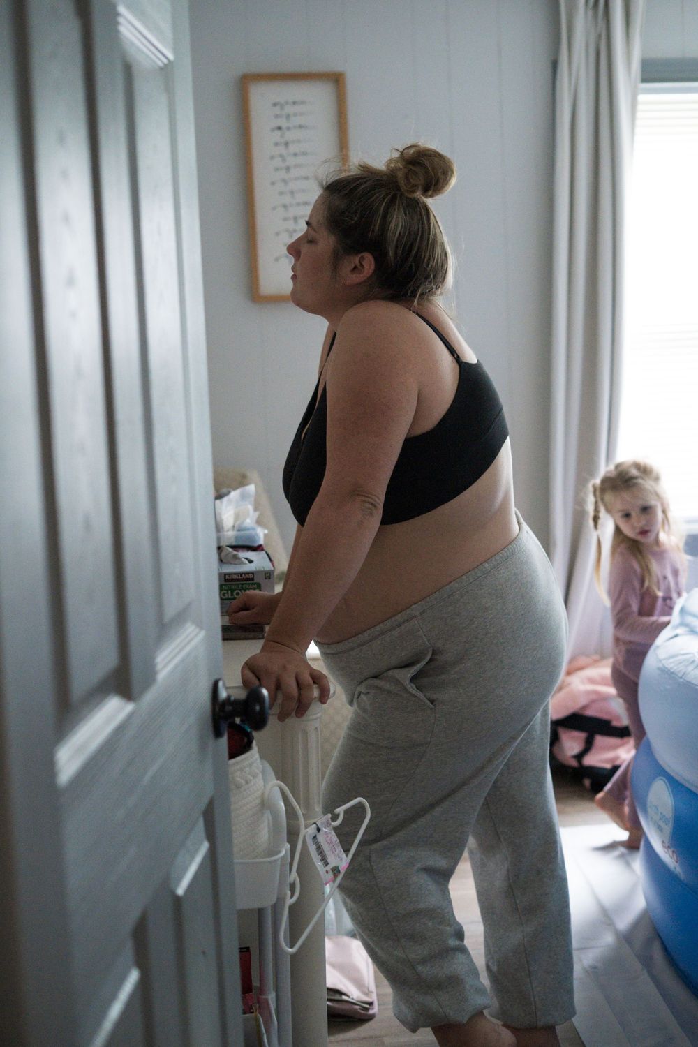 A series of photos showing someone in labor standing by a hospital bed during childbirth.