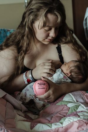 A tender moment showing parent and child lying together on pink bedding in a series of intimate photographs.