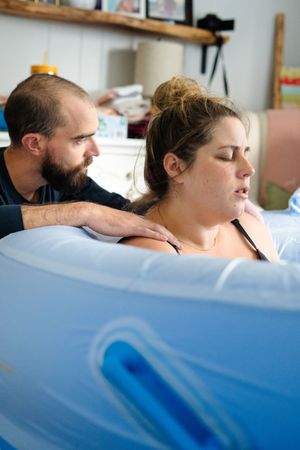 Close-up shots showing the progression of labor and delivery in a hospital room.