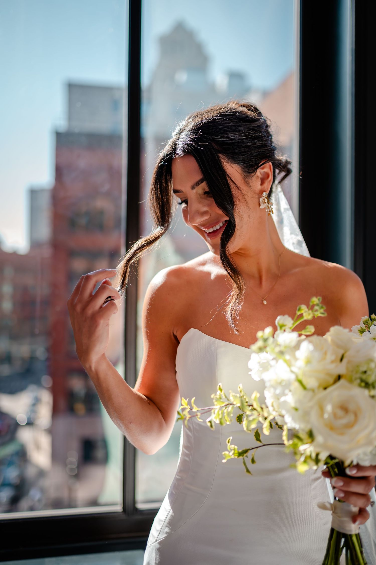 A series of wedding photos showing a bride in a white strapless dress holding a bouquet of white and yellow flowers.