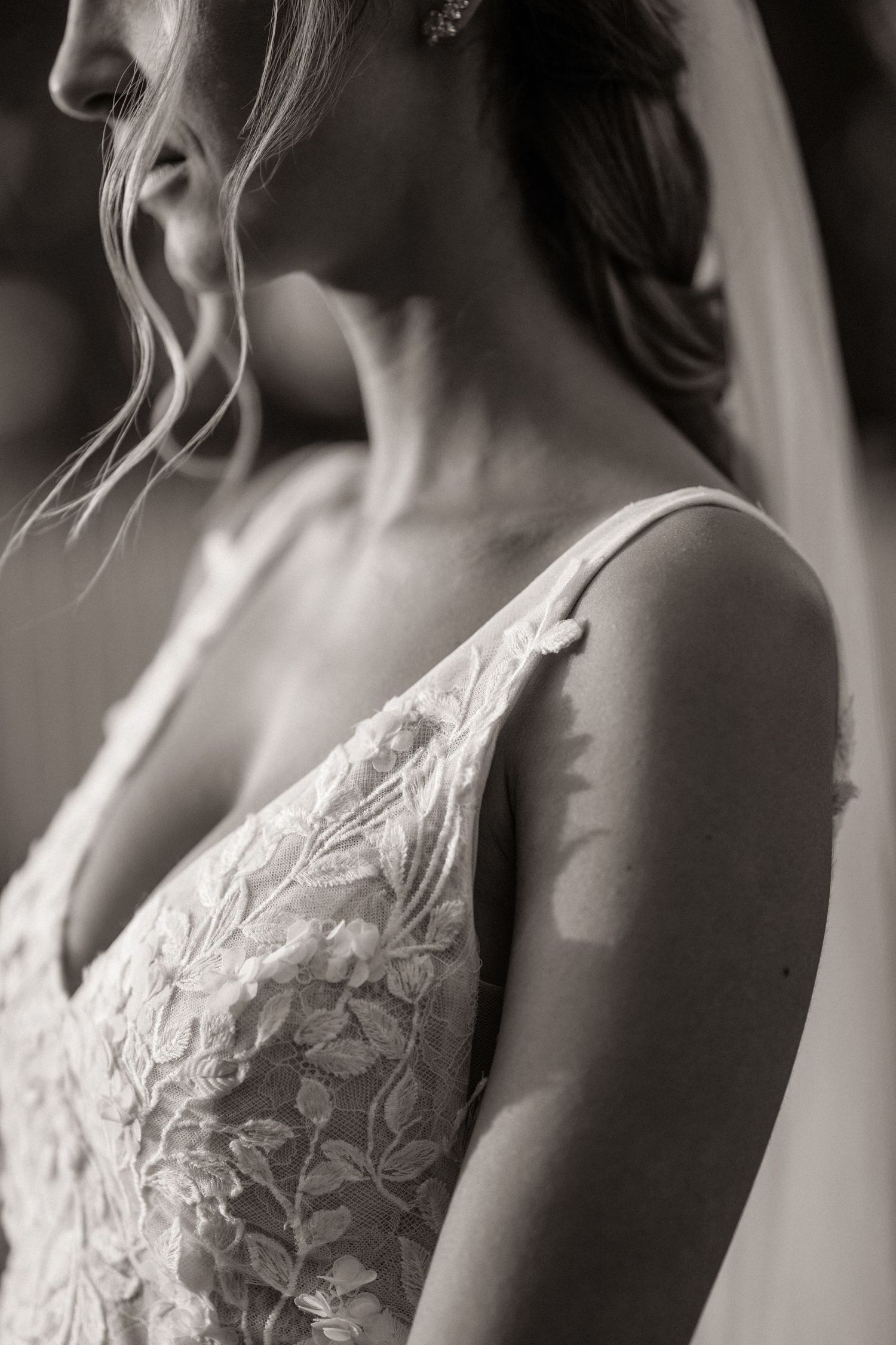Black and white close-up detail shots of a delicate lace wedding dress bodice from multiple angles.