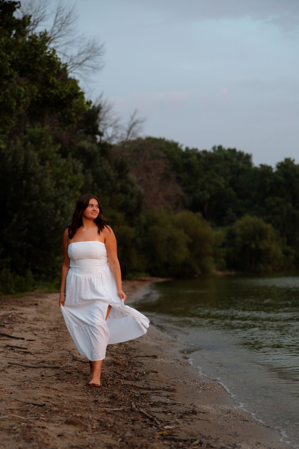 A collection of beach portraits showing a white dress against a moody lakeside backdrop with overcast skies.