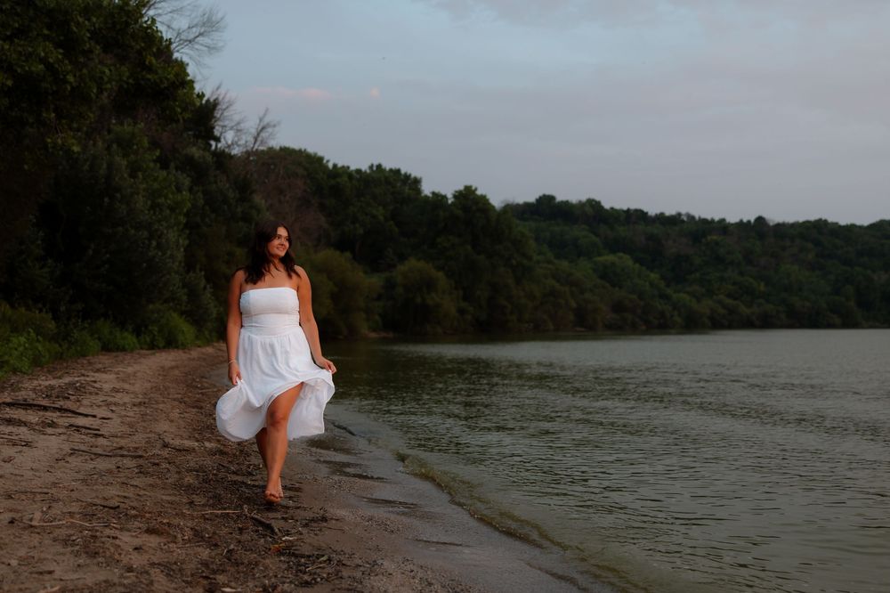 A series of tranquil lakeside photos showing a figure in white walking along a dirt path near the water's edge.