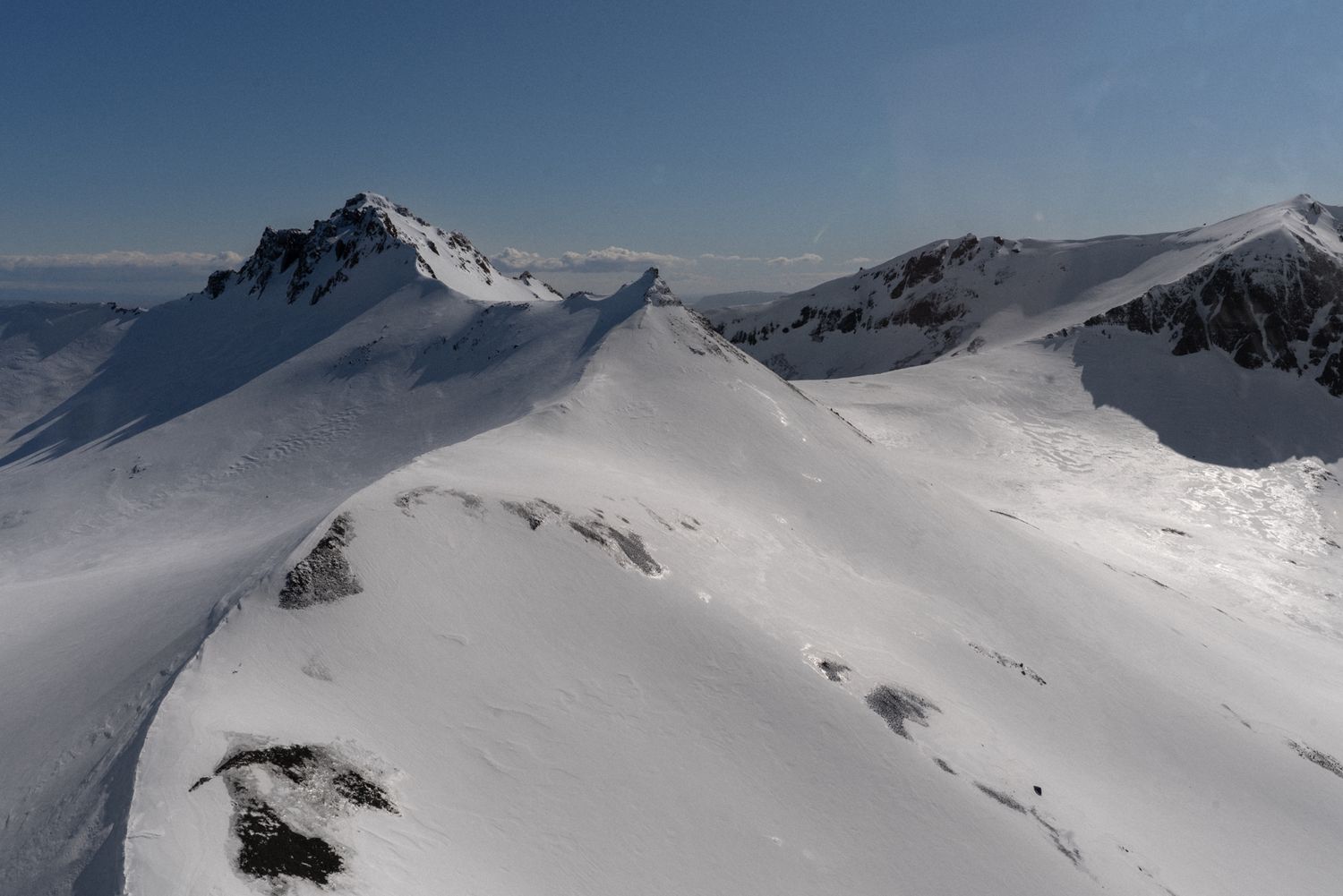 Snow-covered mountain peaks and glaciers in a dramatic winter landscape.