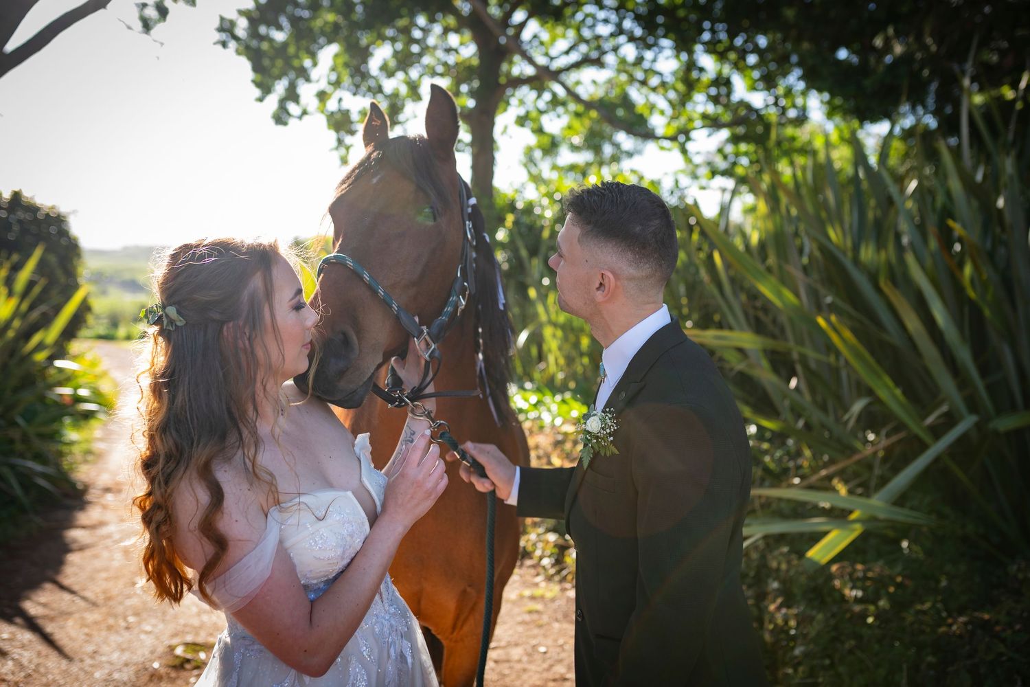 Romantic couple shares intimate moments in a lush garden setting during golden hour photography session.