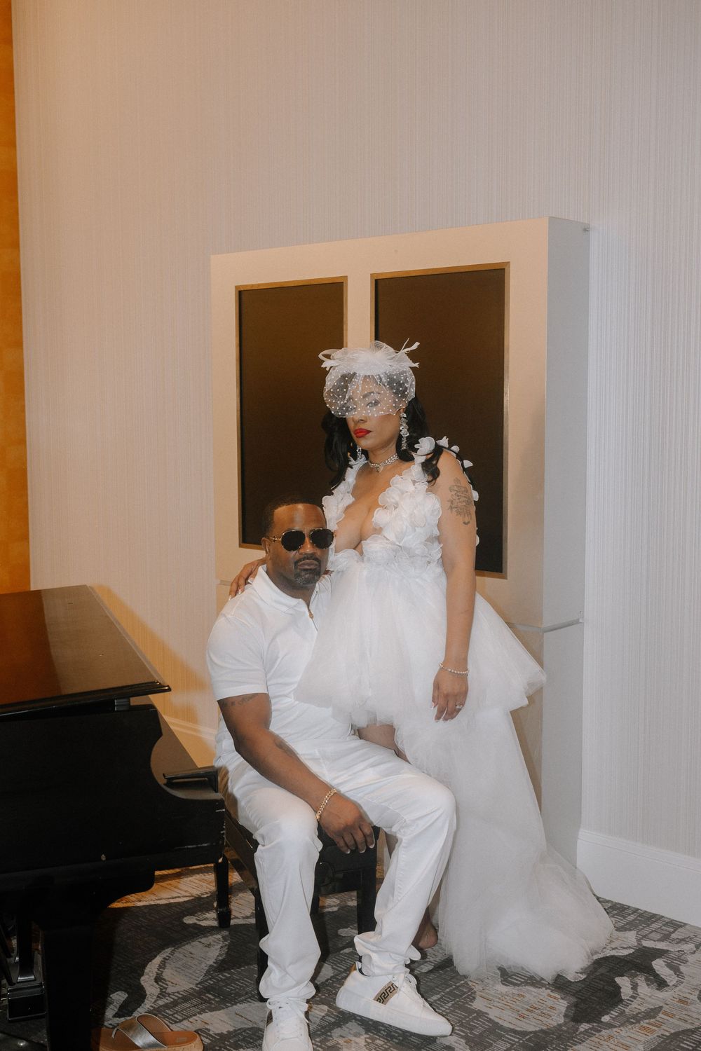 A series of artistic black and white photos showing someone in a white puffy dress and sunglasses sitting on the floor.