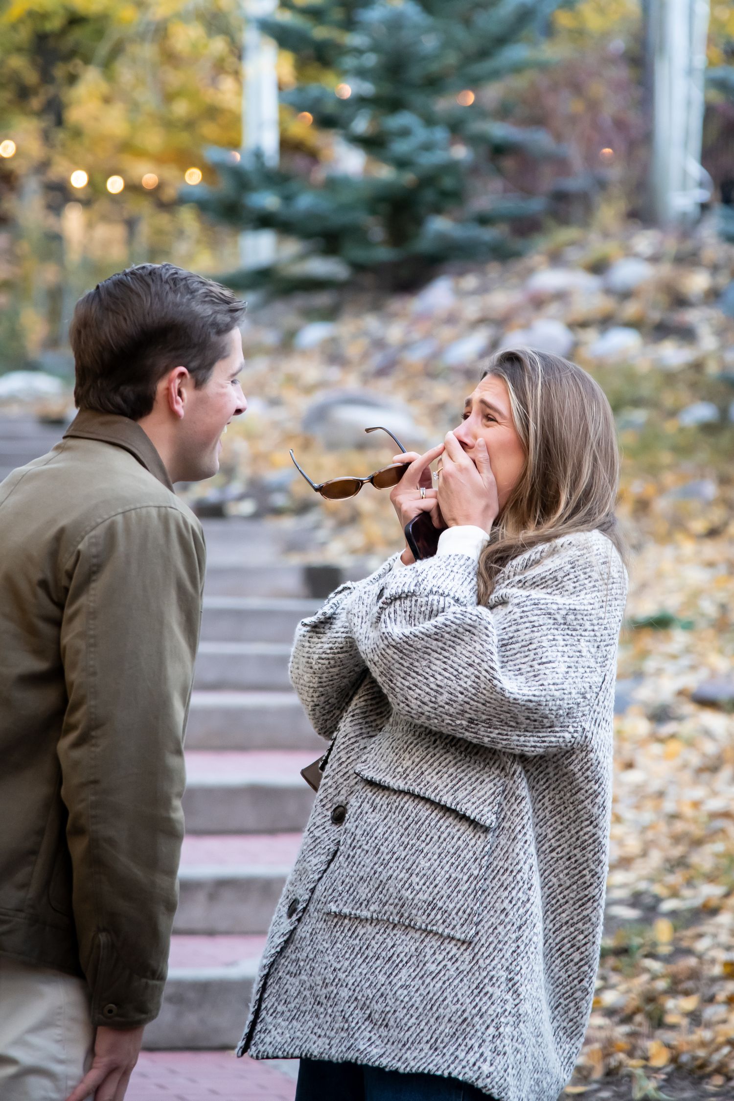 Candid reaction of a woman after a surprise proposal in a romantic fall setting in Vail Colorado