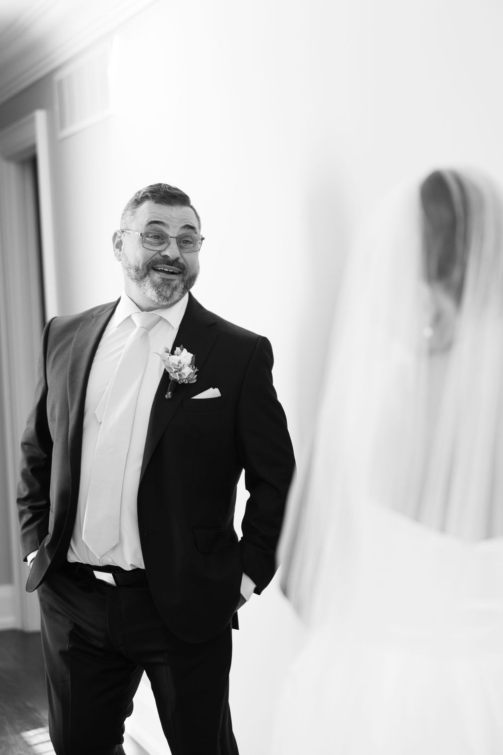 A black and white photo series showing someone in a tuxedo and bow tie smiling and posing playfully.