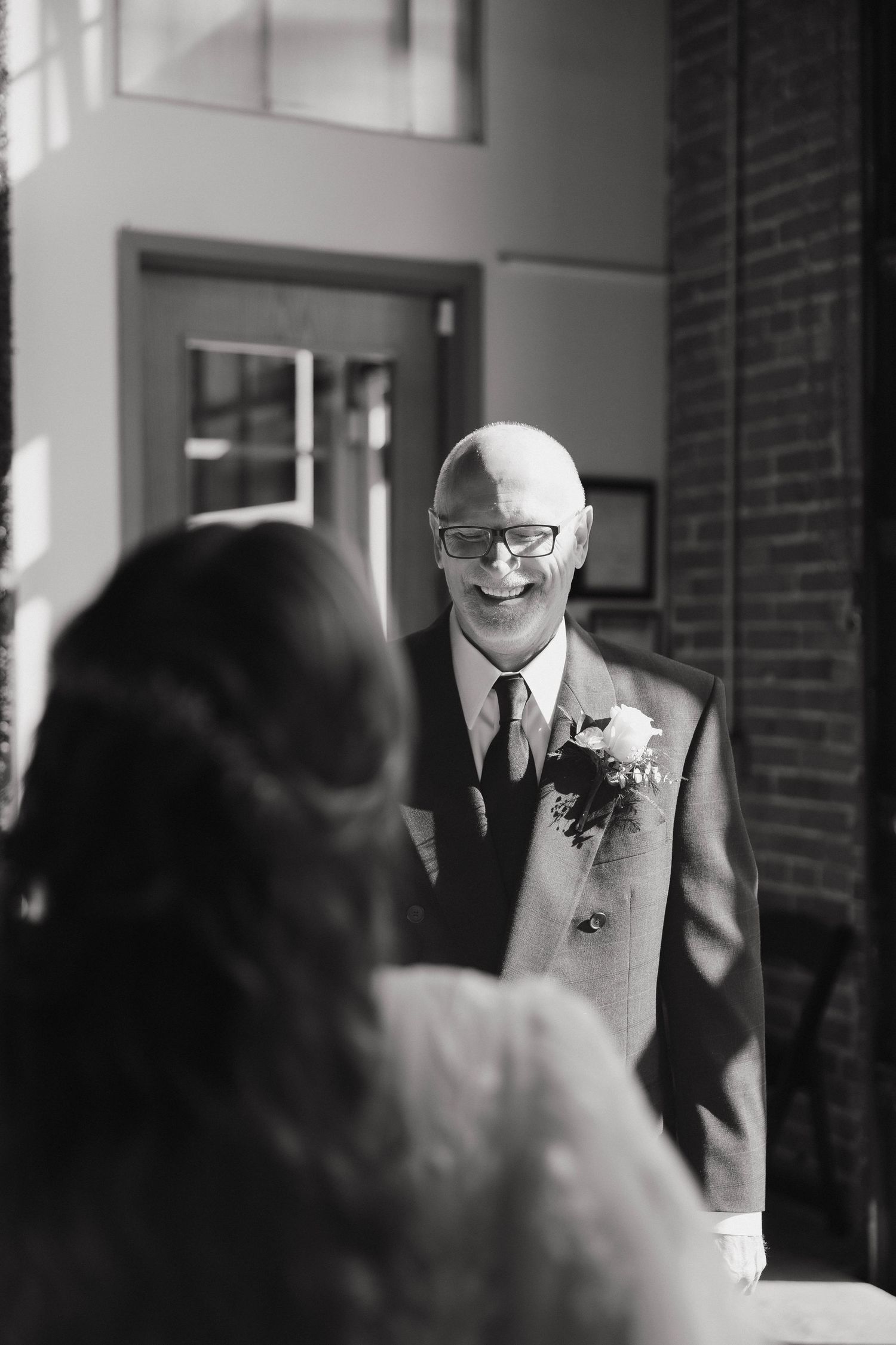 Black and white photos show a person in a suit smiling during a wedding ceremony.
