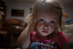 Artistic low-light portrait with dramatic shadows and lighting effects.
