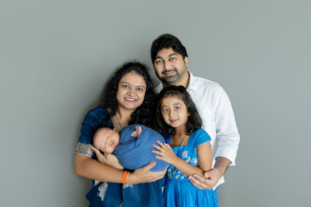 A family wearing blue and white outfits poses together in a series of candid photos against a neutral background.