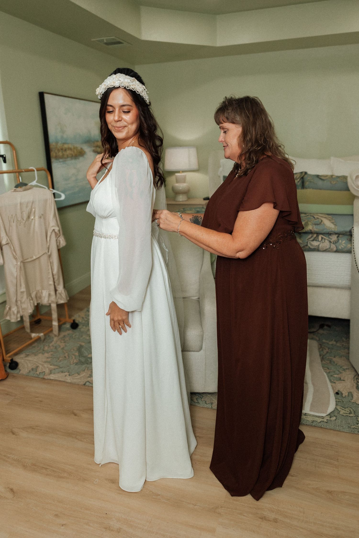 A series of photos showing dress fitting and adjustments being made to a white wedding gown in a bright room.