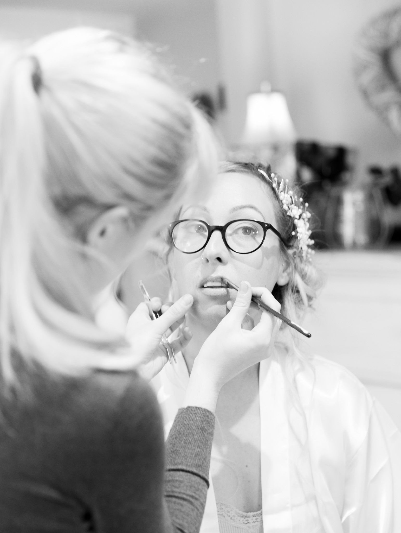 A series of black and white wedding preparation photos showing styling and getting ready moments.