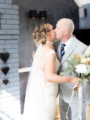 A romantic wedding sequence showing a couple in white sharing kisses against a brick wall with decorative heart accents.