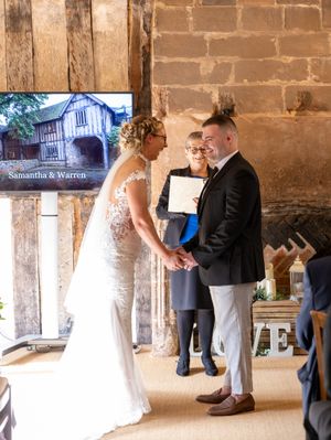 A romantic wedding couple shares intimate moments in a rustic stone archway corridor during their special day.