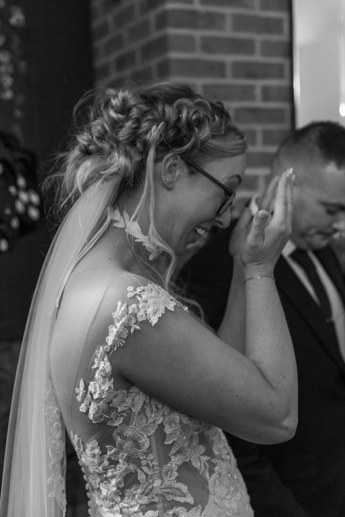 A sequence of black and white photos showing an emotional moment as someone in a wedding dress wipes away tears.