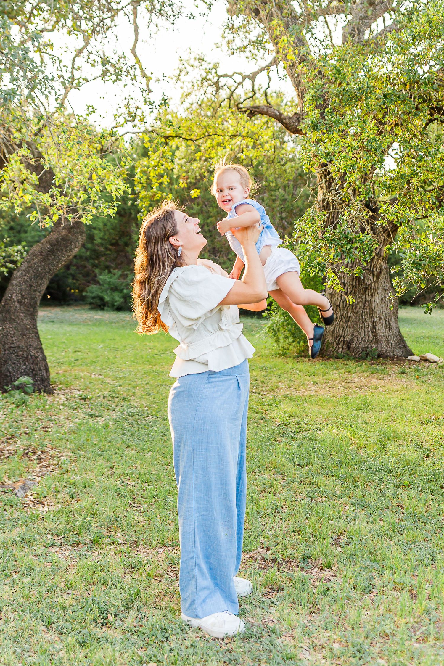A sequence of playful moments captured in a grassy orchard setting during a sunny afternoon.
