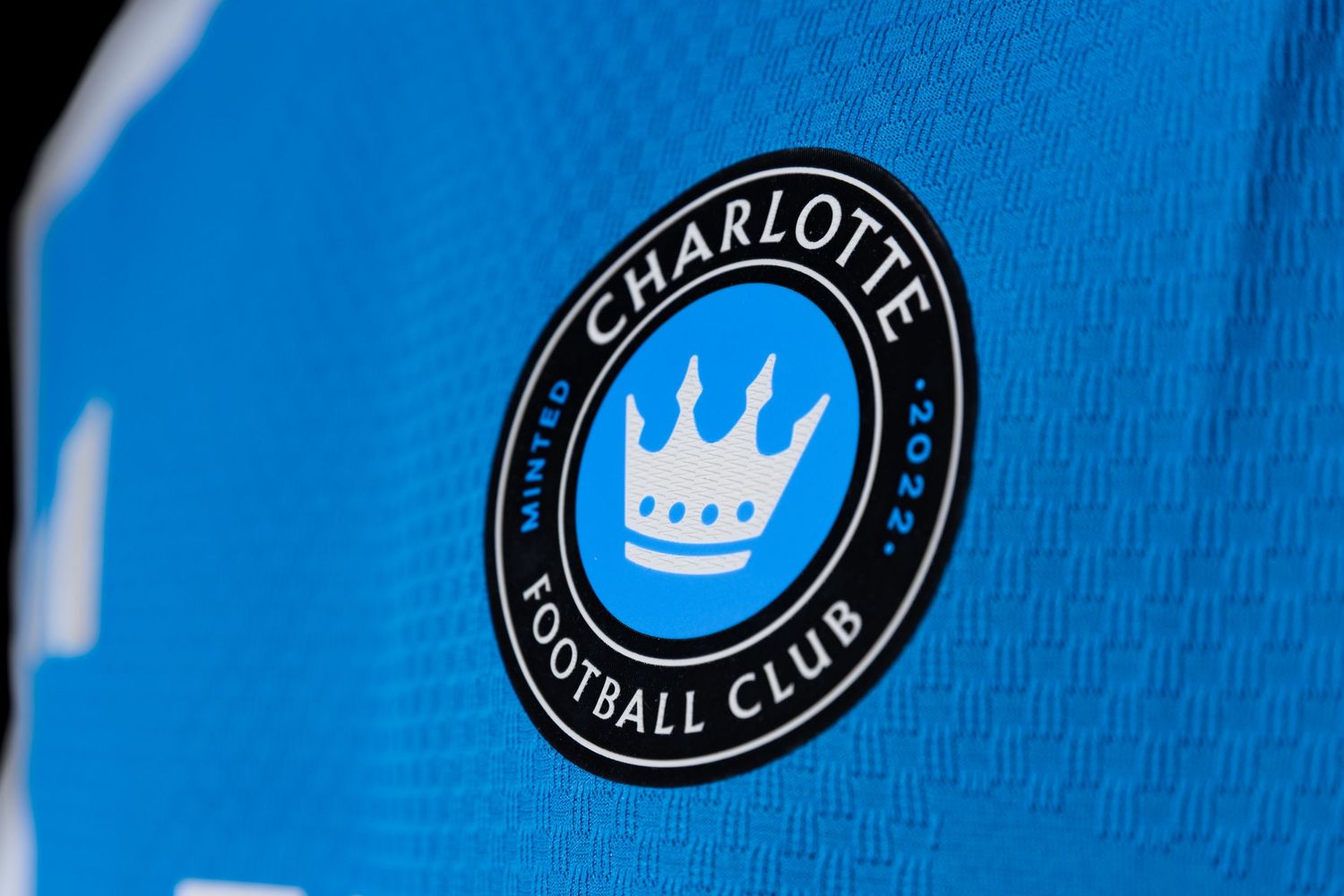 Charlotte Football Club official crest badge on blue MLS soccer jersey.