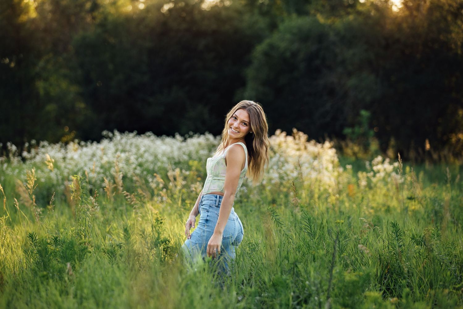 Best senior portraits in Sioux Falls, South Dakota with Rowan Tree Photography in flower fields with magical lighting and a fun experience.